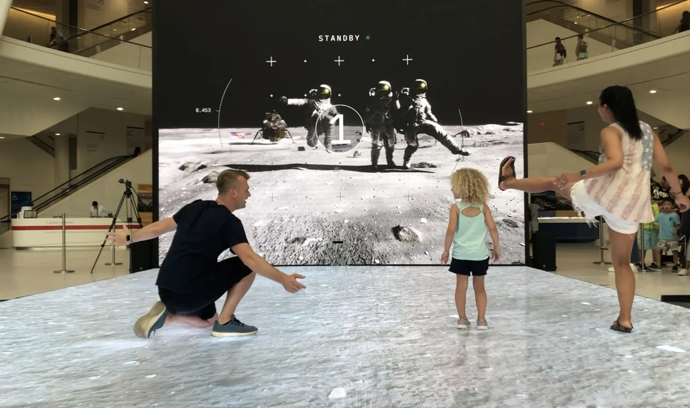 Visitors interacting with the Apollo installation